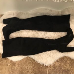 Black over the knee boots with 4 inch heel.